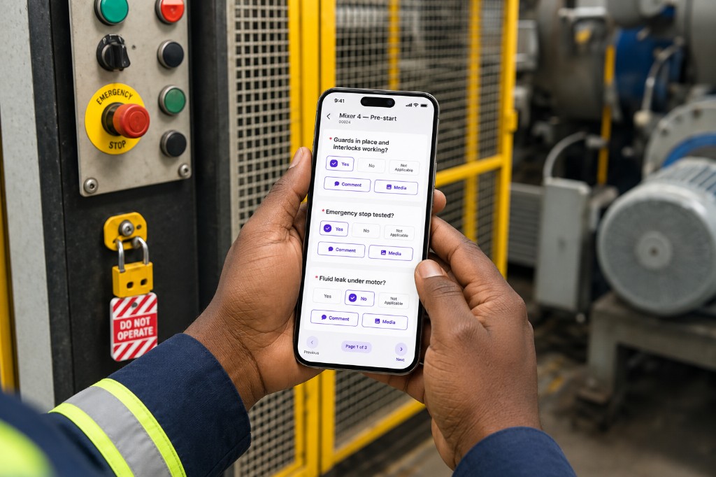 Operator completing a mixer pre-start checklist on a phone beside a lockout tag